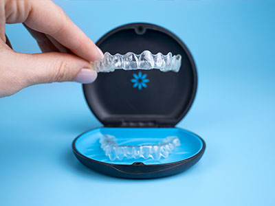 An open case displaying a set of dental implants with a clear, blue background.